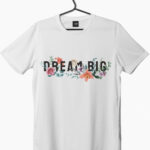 A floral Dream Big written on a white short sleeve t-shirt