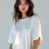 a women wearing a white baggy t-shirt