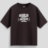 Brown oversized unisex T-shirt with Malayalam text "Thrissurkaran" and mustache graphic in white print, representing Thrissur culture.