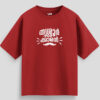 Red oversized unisex T-shirt with Malayalam text "Thrissurkaran" and mustache graphic in white print, representing Thrissur culture.