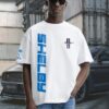 Shelby Mustang T-Shirt featuring blue GT350 car graphic on oversized white t-shirt, worn by model outdoors near Mustang car.