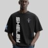 Model wearing the Bold Shelby Mustang T-Shirt in black featuring a fierce red GT350 car print and iconic Shelby branding—crafted for true car lovers.